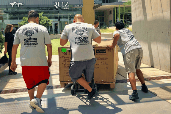 MuscleMan Elite crew rolling a box on the street