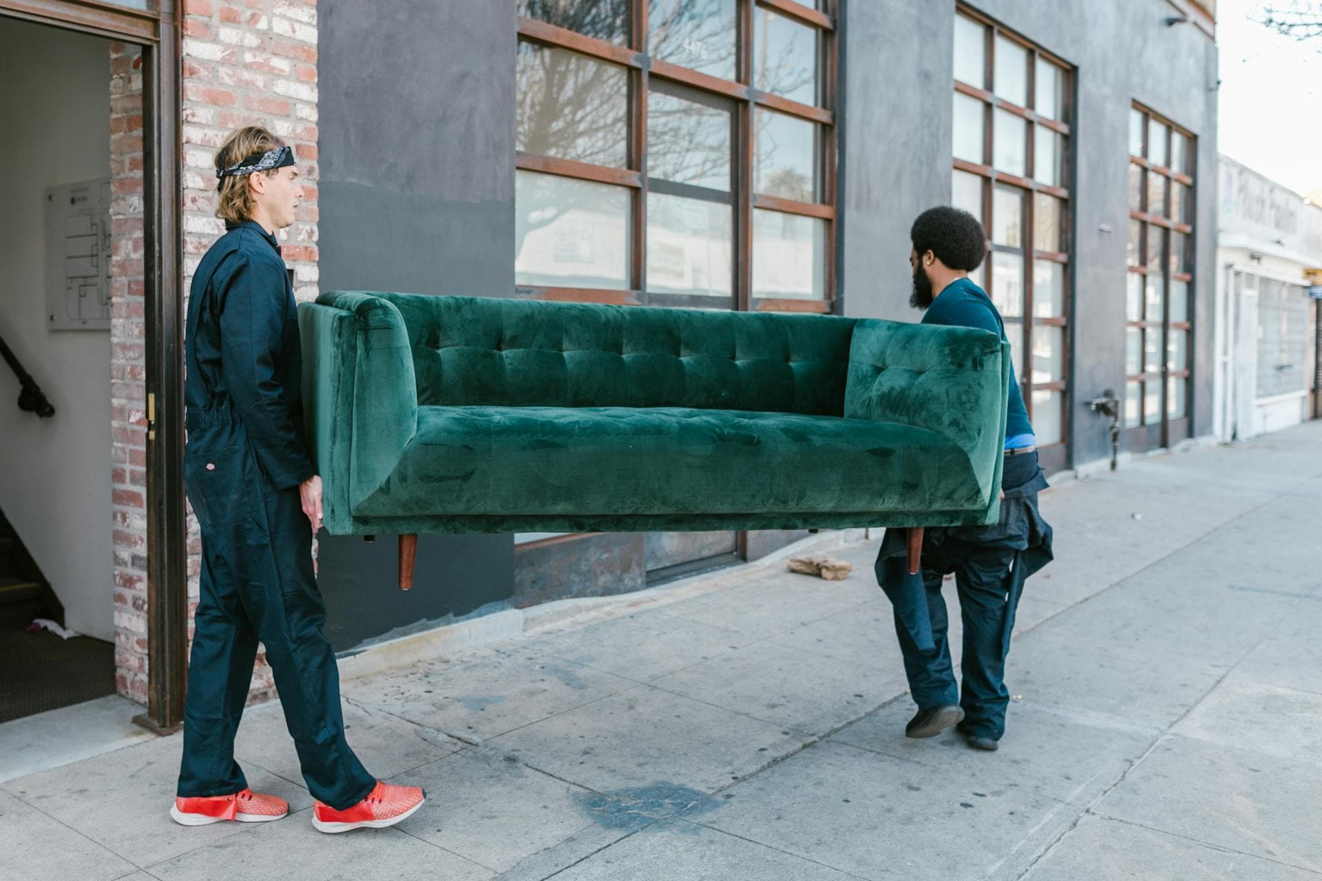 Professional movers moving a couch