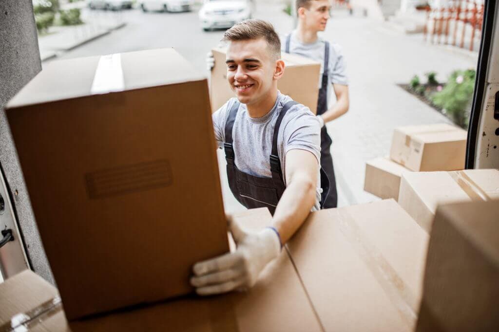 Movers pulling a box from truck
