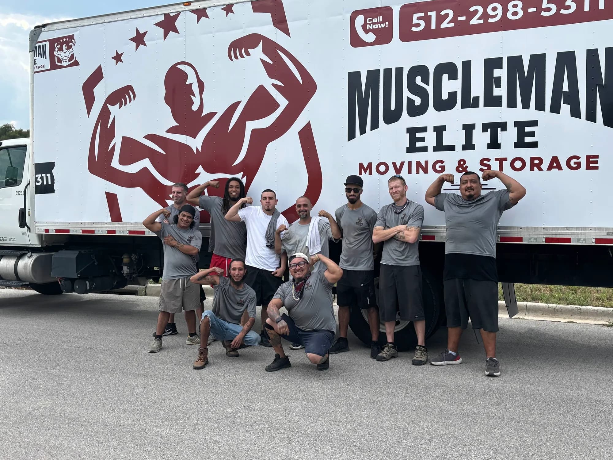 Muscleman Elite crew in front of the branded box truck on a Hays County job