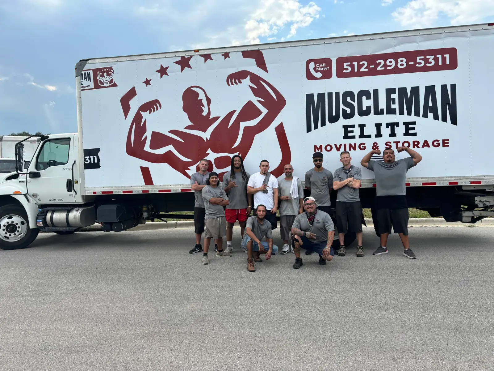 Muscleman Elite crew lined up in front of the branded box truck before a long-distance move
