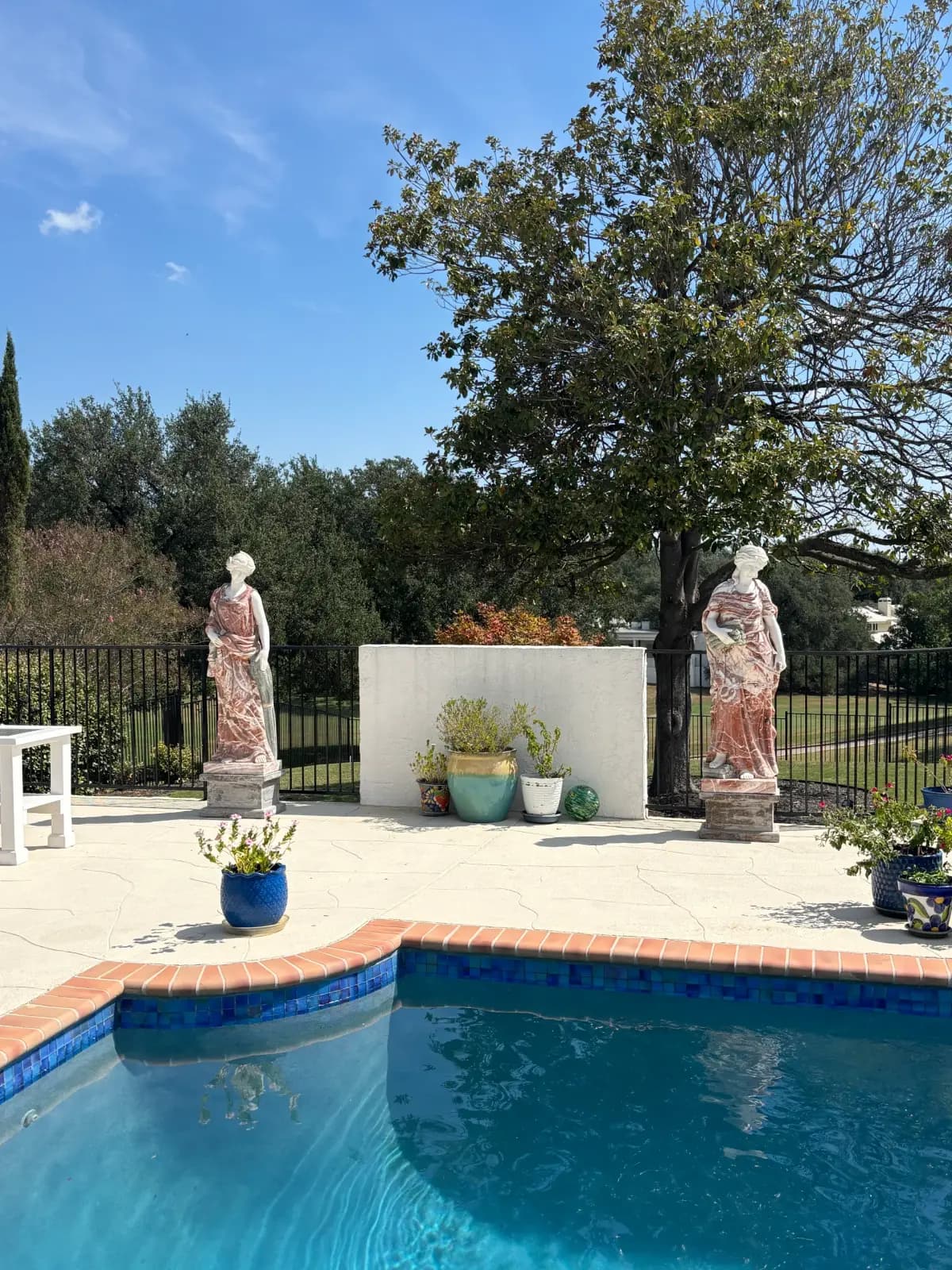 A pair of ornate marble statues at a Hill Country estate handled by Muscleman Elite