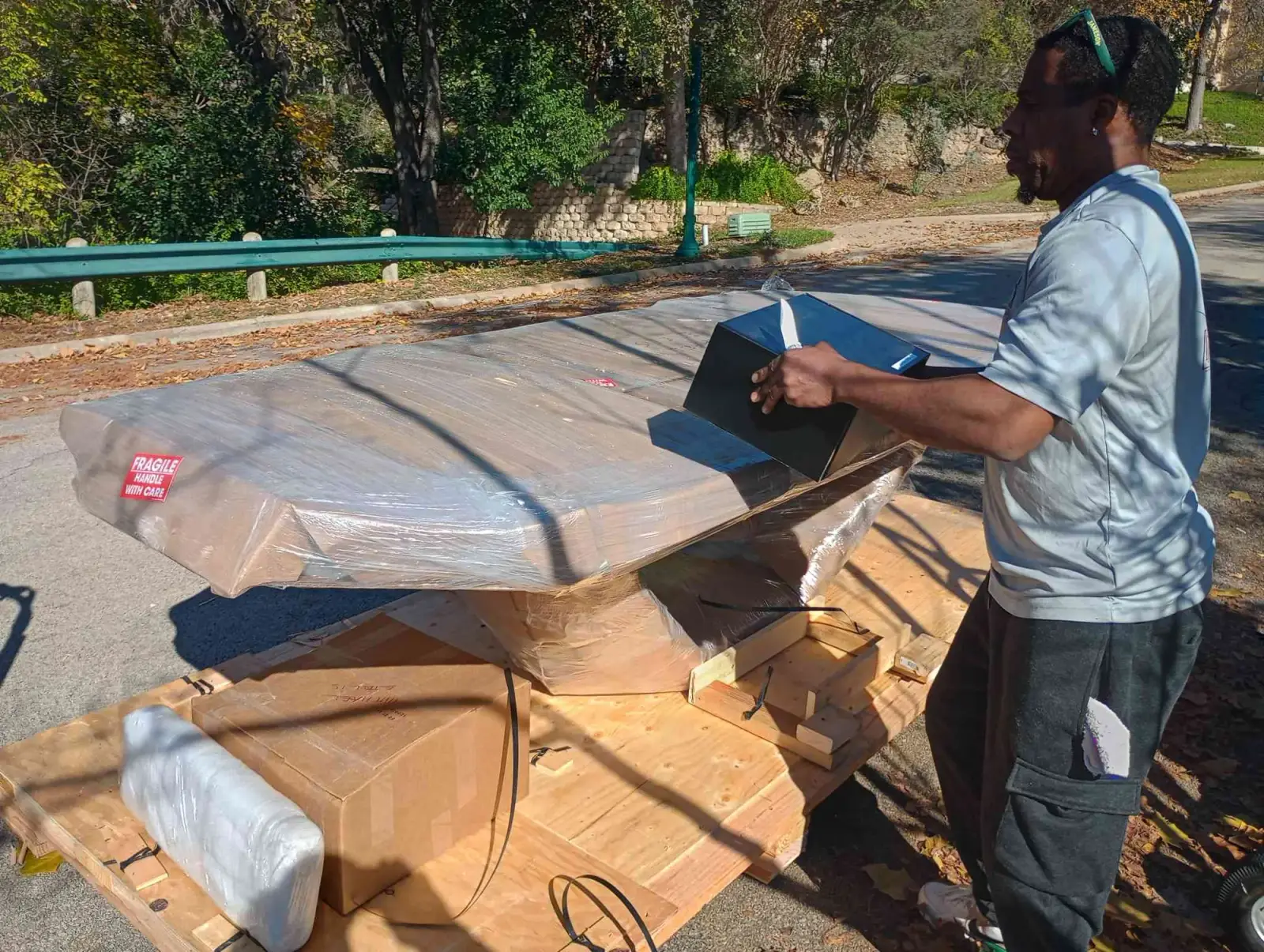 Muscleman Elite mover loading a crated slate pool table for transport