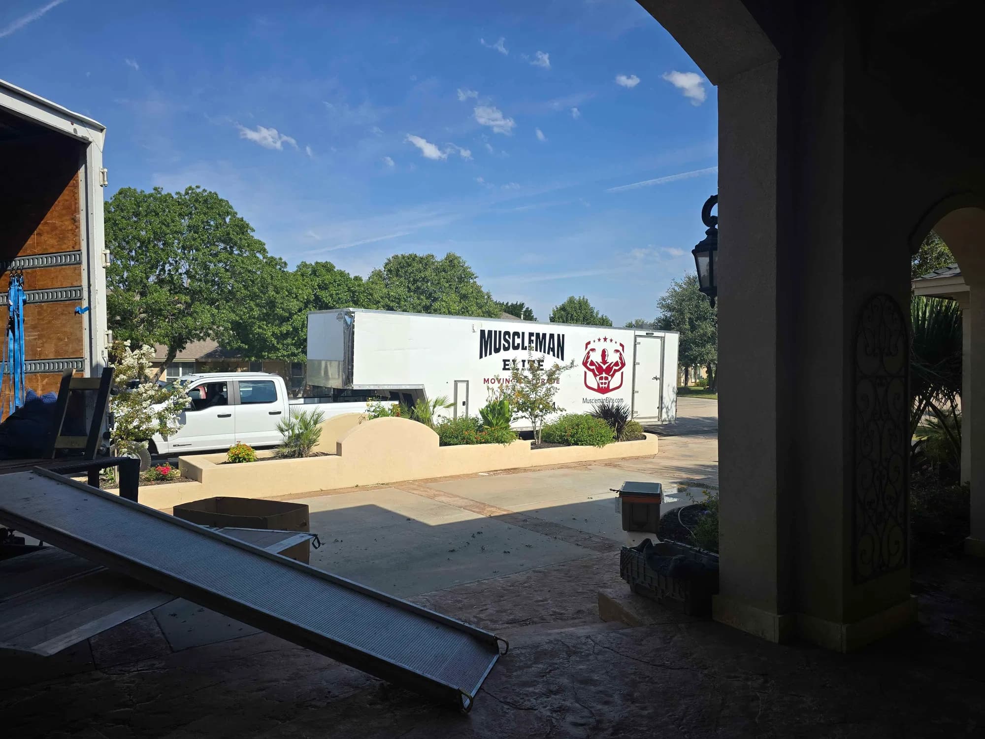 Muscleman Elite truck, trailer, and crew at a Hill Country estate near Dripping Springs