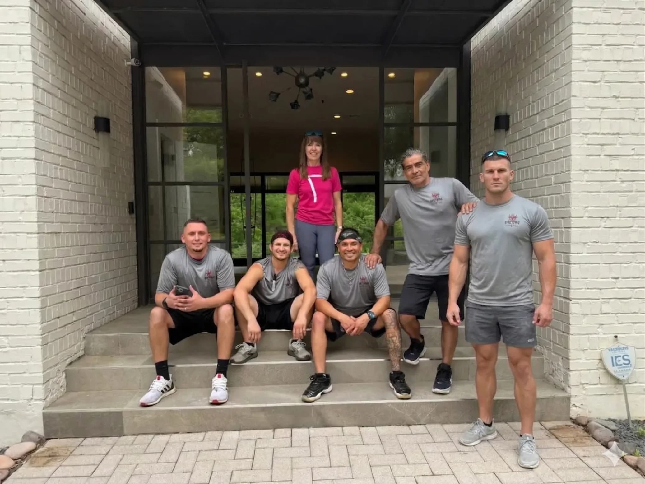 Muscleman Elite crew of professional movers on the front steps of a Texas home