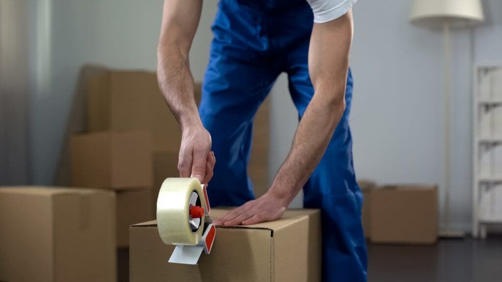 Professional mover packs a box