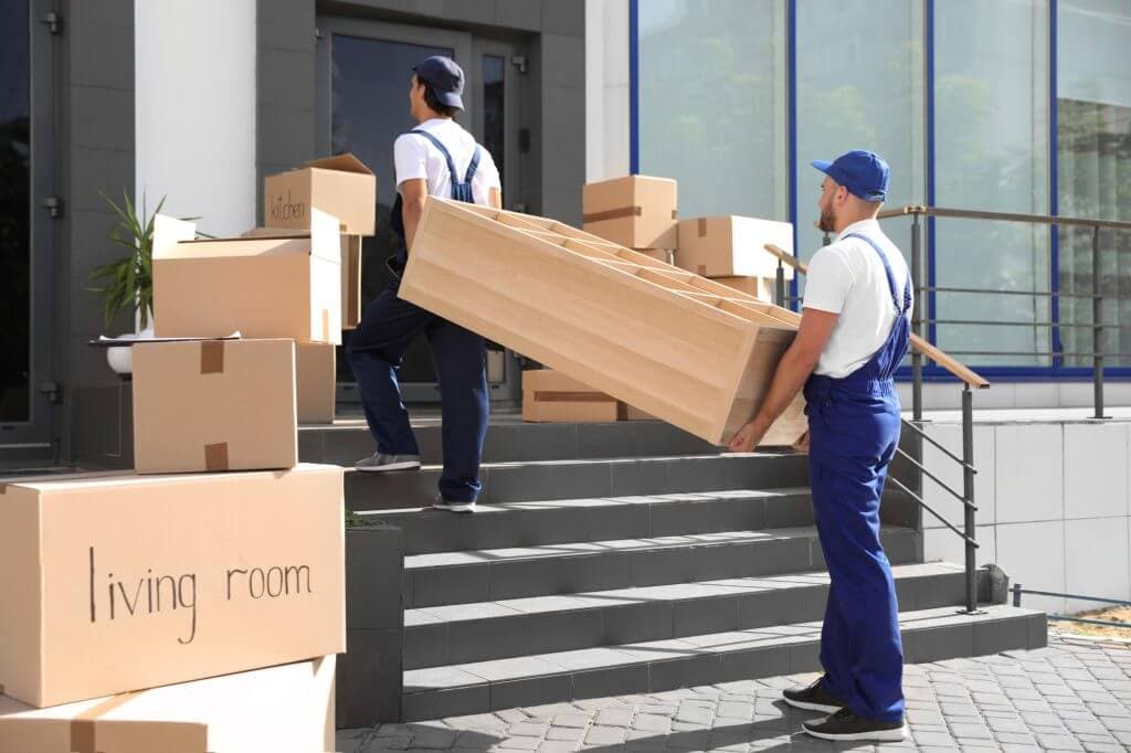Professional movers carrying furniture