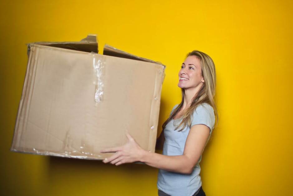 Smiling woman holding a box