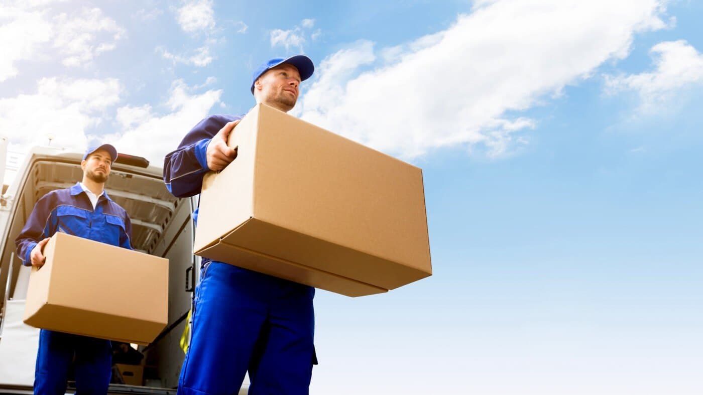 Two movers carrying boxes