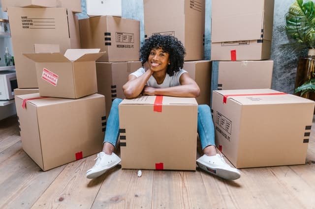 Woman sitting between boxes
