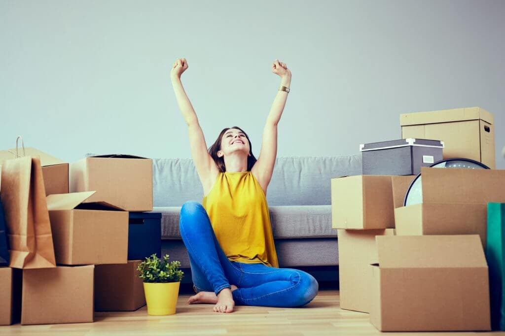 Young lady amidst moving boxes