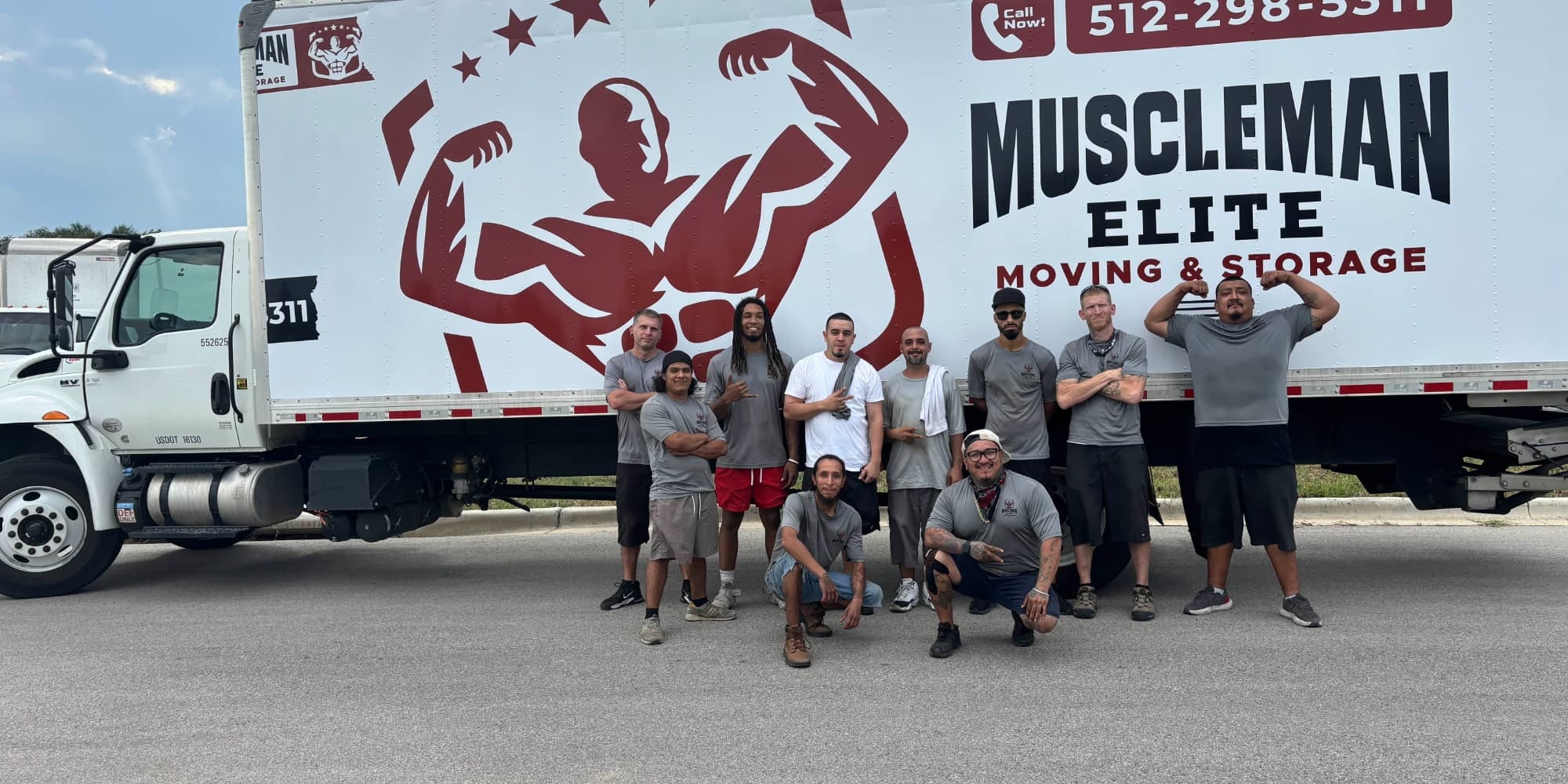 Muscleman Moving crew loading belongings into box truck