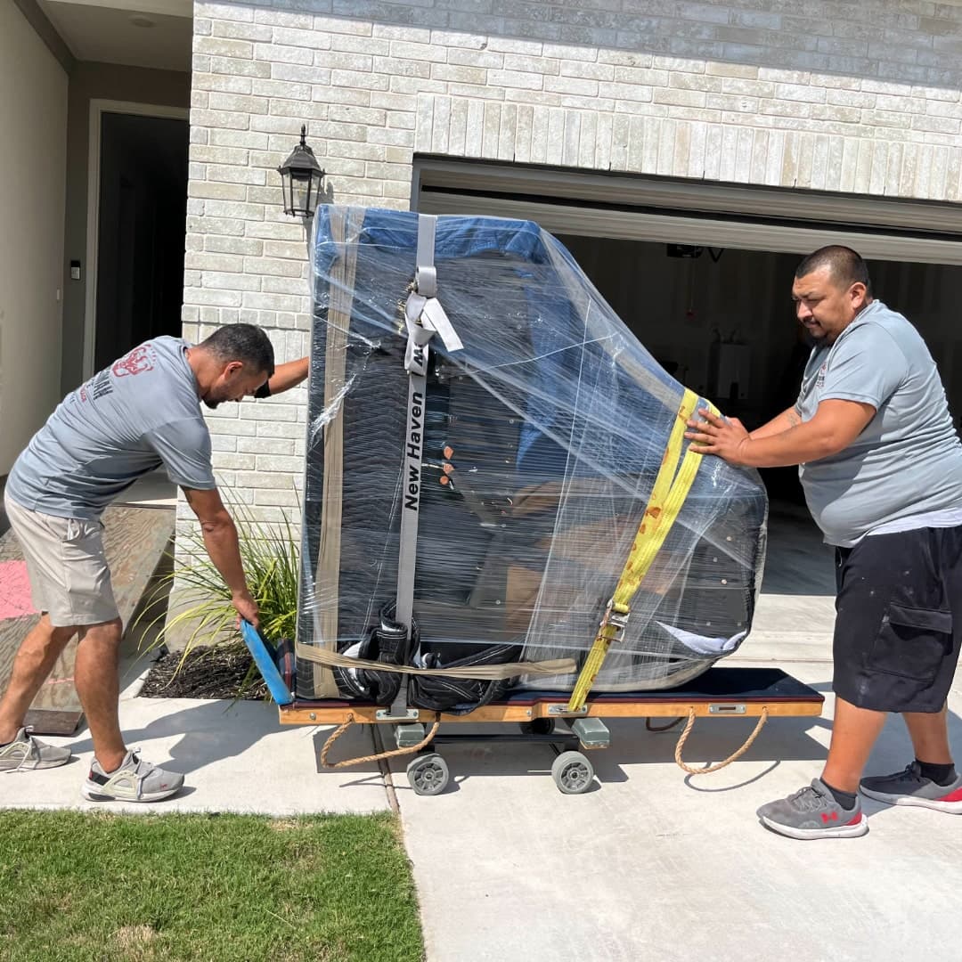 Piano mover securing straps on an upright piano