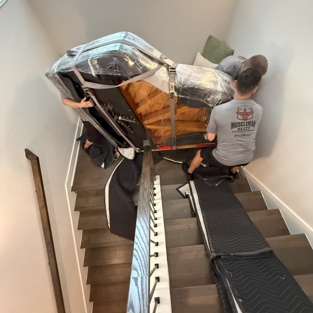 MuscleMan Elite team positioning a piano in a new home