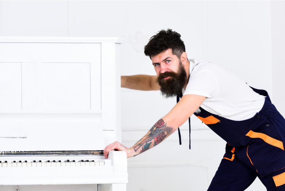 Mover pushing a piano