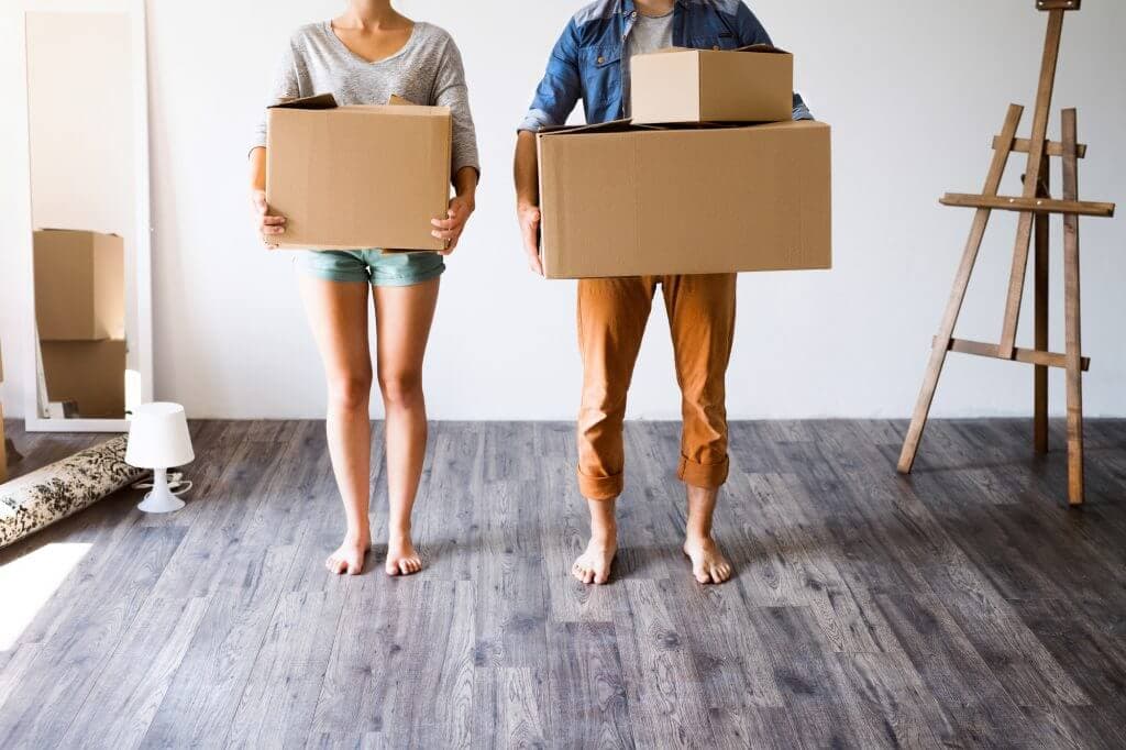 Young couple holding boxes