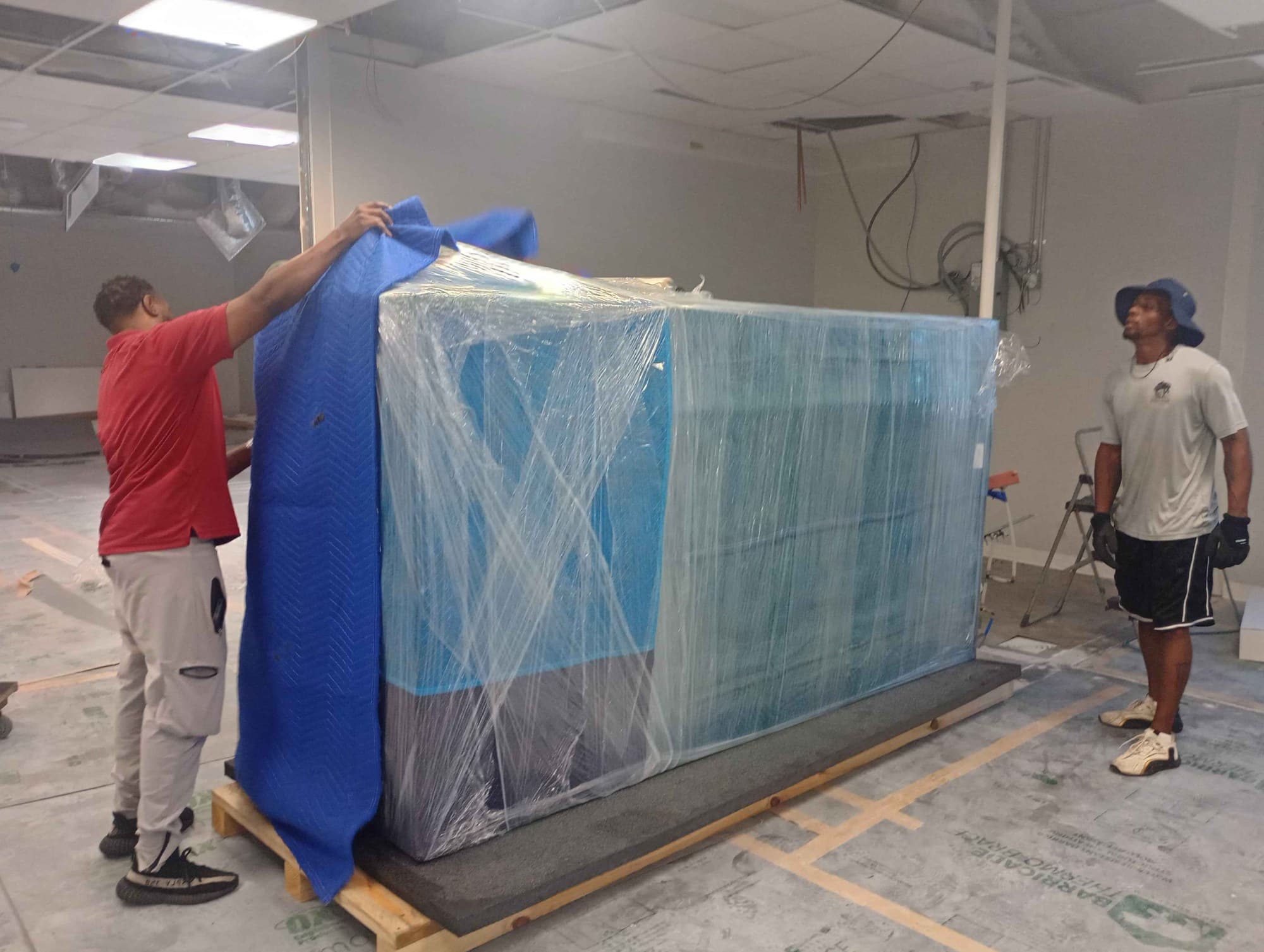 Muscleman Elite crew building a custom crate around a large item