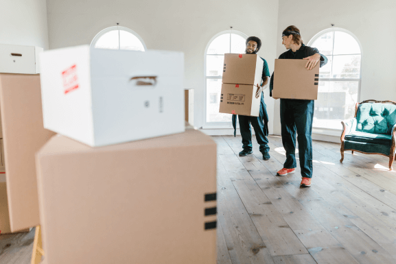 2-movers-holding-boxes.png