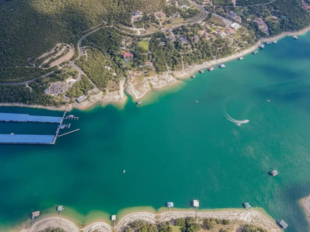 Lake Austin aerial view with a boat moving in the water.