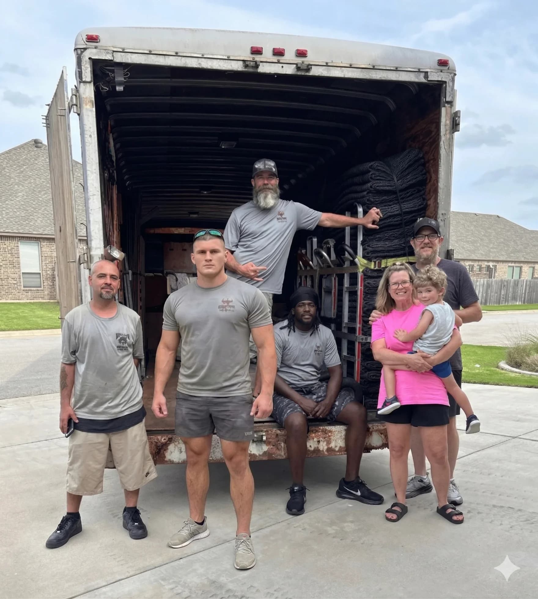 Muscleman Elite Moving crew carefully wrapping furniture during an Austin residential move